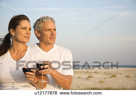 Stock Photo - Couple Drinking Wine on Beach. Fotosearch