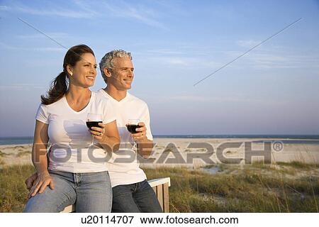 Stock Photo - Couple Drinking Wine on Beach. Fotosearch