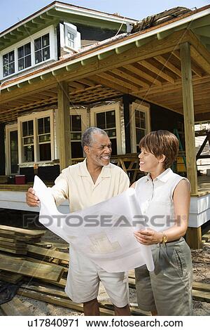 Couple Holding Building Plans View Large Photo Image Stock Image - Couple Holding Building Plans. Fotosearch