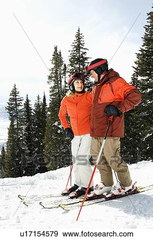 Stock Photo - Couple on Skis on Mountain Slope. Fotosearch