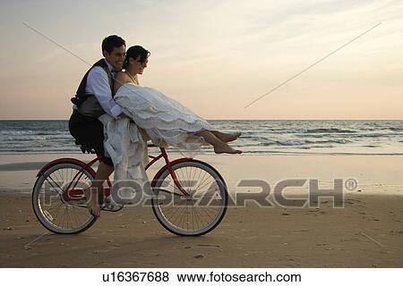 Couple Riding Bike on Beach View Large Photo Image Stock Photo - Couple Riding Bike on Beach. Fotosearch