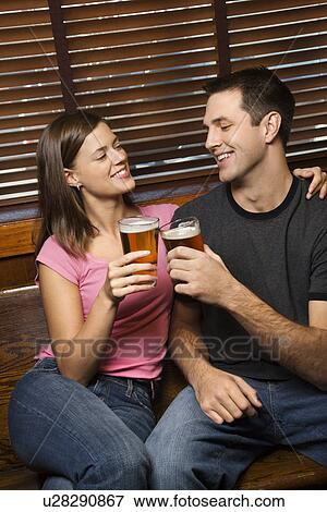 Couple Toasting Their Beers View Large Photo Image Stock Photo - Couple Toasting Their Beers. Fotosearch