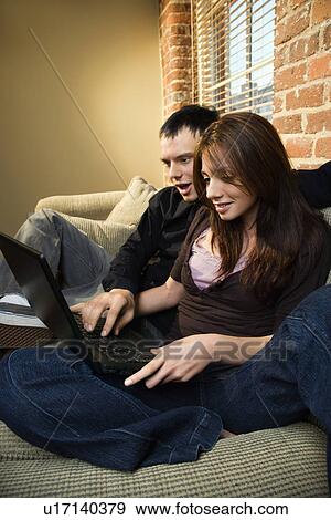 Couple using computer View Large Photo Image Stock Photo - Couple using computer. Fotosearch