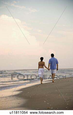Couple Walking on Beach View Large Photo Image Picture - Couple Walking on Beach. Fotosearch