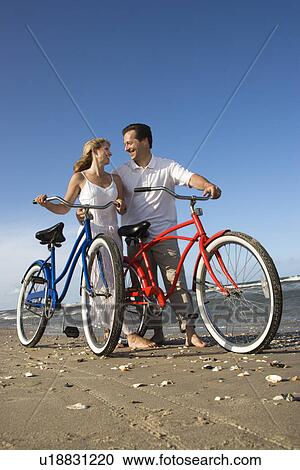Couple with Bikes at the Beach View Large Photo Image Stock Image - Couple with Bikes at the Beach. Fotosearch
