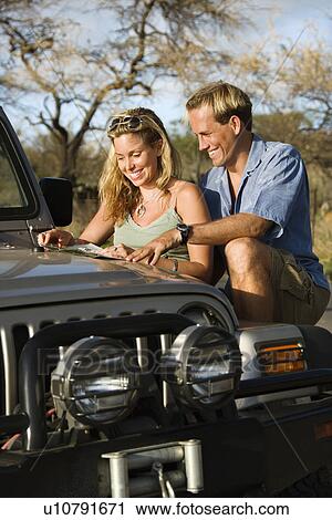 Couple With Map on Car Hood View Large Photo Image Stock Image - Couple With Map on Car Hood. Fotosearch