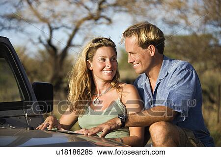 Couple With Map on Car Hood View Large Photo Image Stock Photography - Couple With Map on Car Hood. Fotosearch
