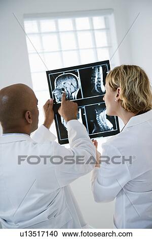 Stock Image - Doctors analyzing xray.. Fotosearch