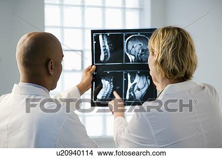 Doctors looking at xray. View Large Photo Image Picture - Doctors looking at xray. . Fotosearch