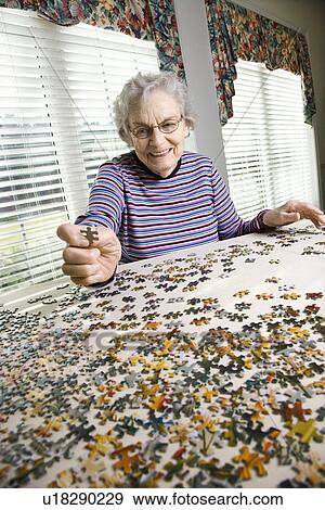Elderly Woman Doing Jig Saw Puzzle View Large Photo Image Stock Photo - Elderly Woman Doing Jig Saw Puzzle. Fotosearch