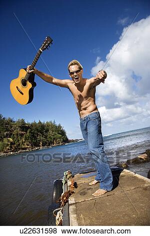 Enthusiastic Young Man With Guitar Standing Lakeside View Large Photo Image Stock Photo - Enthusiastic Young Man With Guitar Standing Lakeside. Fotosearch