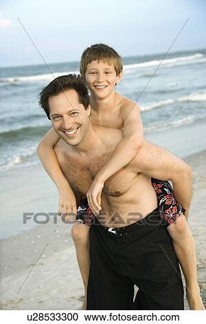 Stock Image - Father and Son at the Beach. Fotosearch