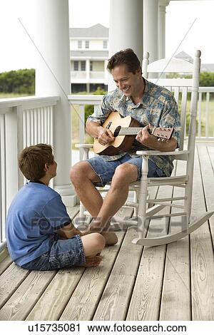 Stock Image - Father and Son on Porch. Fotosearch