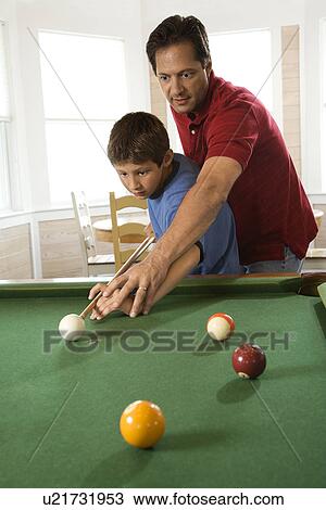 Stock Image - Father and Son Playing Pool. Fotosearch