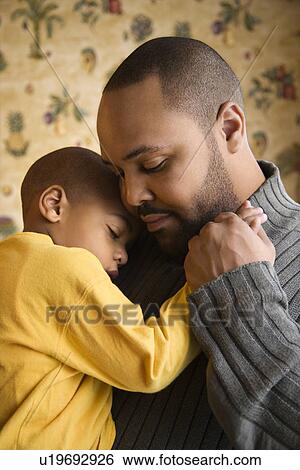 Stock Photograph - Father Smiling Holding Young Son. Fotosearch