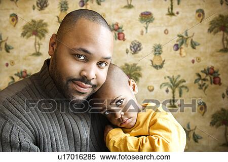 Stock Photography - Father Smiling Holding Young Son. Fotosearch