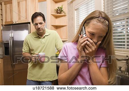 Father watching Daughter on phone View Large Photo Image Stock Photo - Father watching Daughter on phone. Fotosearch