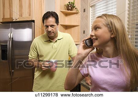 Stock Photo - Father with Daughter on phone. Fotosearch