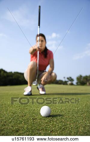 Stock Image - Female Golfer Concentrating. Fotosearch