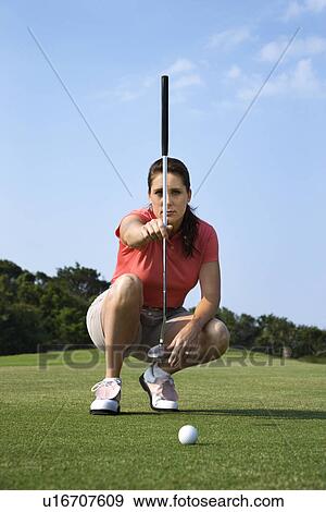Stock Photo - Female Golfer Concentrating. Fotosearch