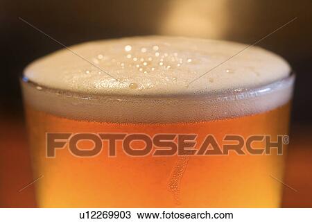 Stock Image - Foam on Glass of Beer. Fotosearch