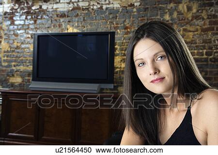 Stock Image - Girl and television. Fotosearch