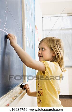 Stock Photo - Girl Writing on Blackboard. Fotosearch