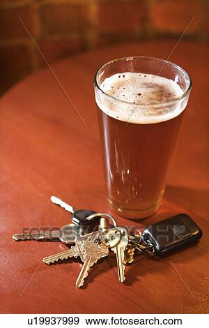Glass of Beer and Keys on Bar Table View Large Photo Image Stock Photo - Glass of Beer and Keys on Bar Table. Fotosearch