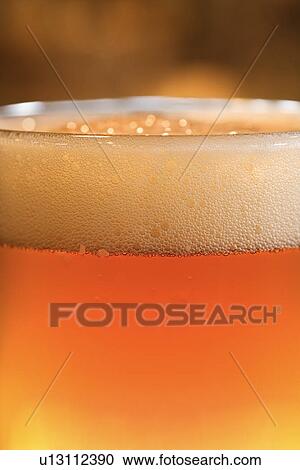 Stock Image - Glass of Beer with Foam. Fotosearch