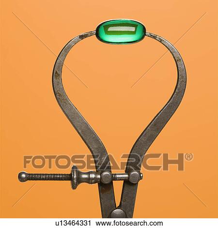 Stock Image - Green Capsule in Caliper. Fotosearch