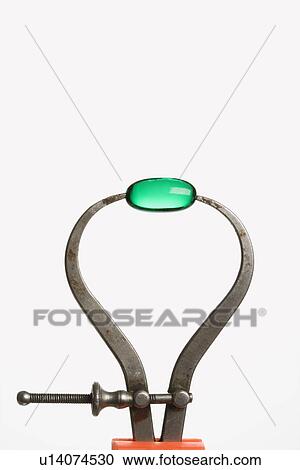 Stock Image - Green Capsule in Caliper. Fotosearch