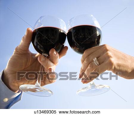 Stock Photography - Hands Toasting with Wine. Fotosearch