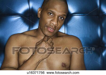 Stock Photograph - Handsome Young Man Shirtless and Smiling. Fotosearch