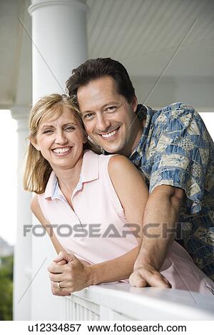 Stock Photo - Happy Couple on Porch of Home. Fotosearch