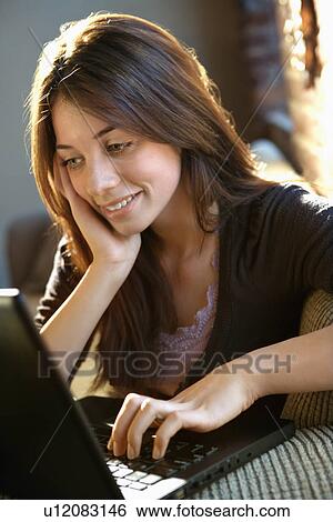 Happy woman using laptop View Large Photo Image Stock Photograph - Happy woman using laptop. Fotosearch