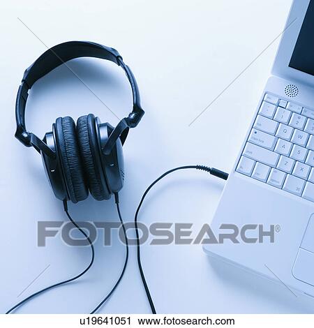 Stock Image - Headphones Connected to Laptop. Fotosearch