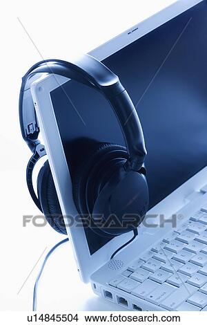Headphones Hanging on Screen of Laptop View Large Photo Image Picture - Headphones Hanging on Screen of Laptop. Fotosearch