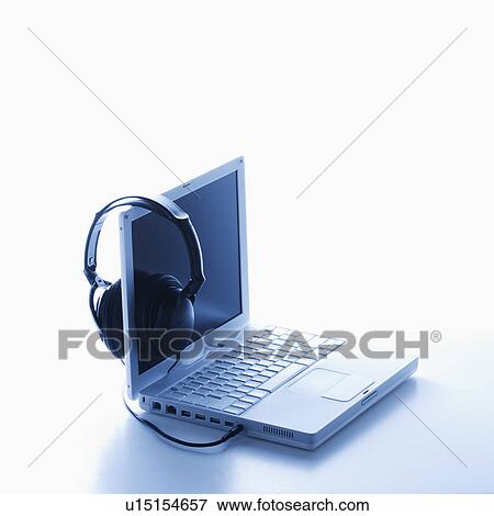 Stock Photo - Headphones Hanging on Screen of Laptop. Fotosearch
