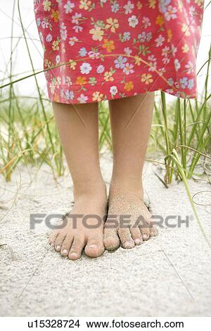 Picture - Little Girl's Feet in the Sand. Fotosearch