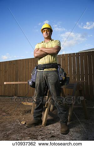 Male Construction Worker Stands with Folded Arms View Large Photo Image Stock Image - Male Construction Worker Stands with Folded Arms. Fotosearch
