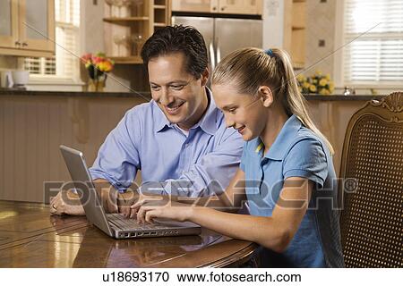 Stock Image - Man and Girl Working on Laptop. Fotosearch
