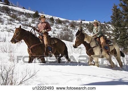 Man and Woman Riding Horses in the Snow View Large Photo Image Stock Image - Man and Woman Riding Horses in the Snow. Fotosearch