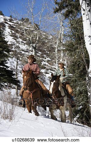 Man and Woman Riding Horses in the Snow View Large Photo Image Stock Photo - Man and Woman Riding Horses in the Snow. Fotosearch