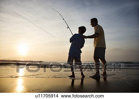 Man and young boy fishing in surf View Large Photo Image Picture - Man and young boy fishing in surf. Fotosearch
