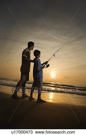 Man and young boy fishing in surf View Large Photo Image Stock Image - Man and young boy fishing in surf. Fotosearch