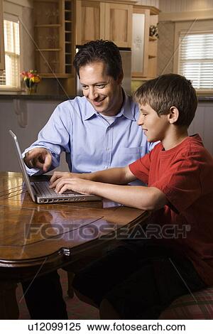 Stock Photography - Man and Young Boy on Laptop. Fotosearch