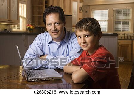 Man and Young Boy with Laptop View Large Photo Image Stock Photograph - Man and Young Boy with Laptop. Fotosearch