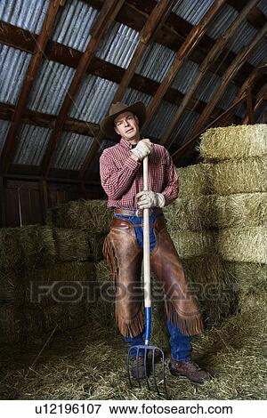 Stock Photo - Man Holding a Pitchfork. Fotosearch