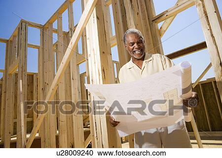Man Holding Building Plans View Large Photo Image Stock Image - Man Holding Building Plans. Fotosearch