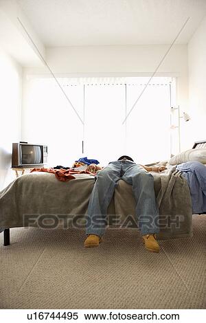 Stock Photography - Man Lying on Bed. Fotosearch